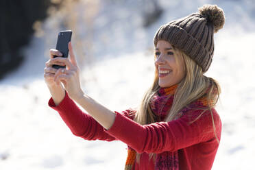 Junge blonde Frau macht ein Selfie im Winter - JSRF00228