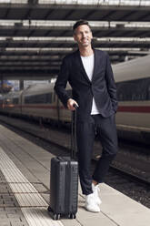 Mature man with trolley on station - PNEF01584