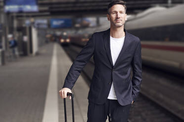 Mature man with trolley on station - PNEF01585