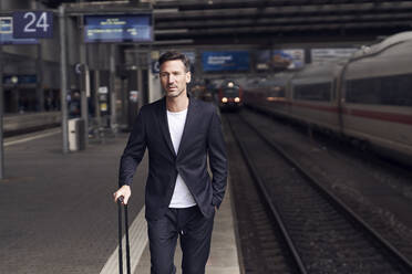 Mature man with trolley on station - PNEF01587