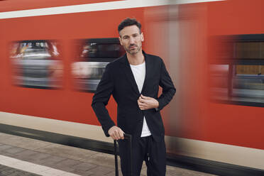 A senior blind man with white cane getting on public transport in city.  stock photo