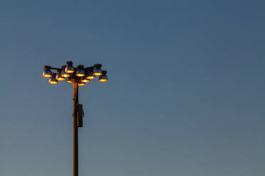 Holophane streetlights against blue sky - MINF12289