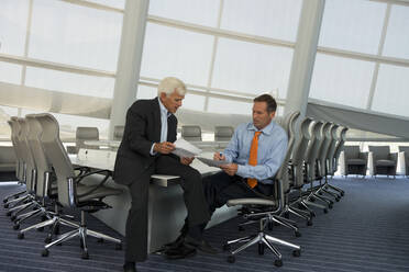 Caucasian businessmen talking in conference room - BLEF06783