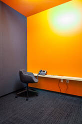 Chair, desk and phone in empty office - MINF12324