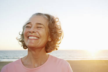 Caucasian woman smiling at beach - BLEF06979