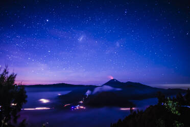 Starry night sky over active volcano - MINF12342