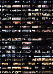 Full frame of highrise building windows at night - MINF12387