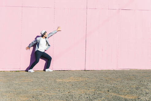 Young man in front of pink construction barrier, feeling trapped - UUF17839