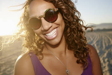 African American woman smiling on beach - BLEF07320