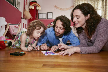 Caucasian family drawing in bedroom - BLEF07326