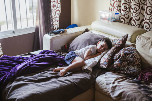 Little boy sleeping on bed couch in the morning - LJF00139