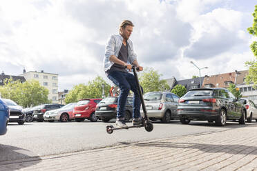 Mann auf E-Scooter springt in die Luft - JOSF03313