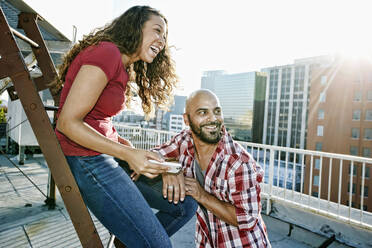 Couple relaxing on urban rooftop - BLEF07437