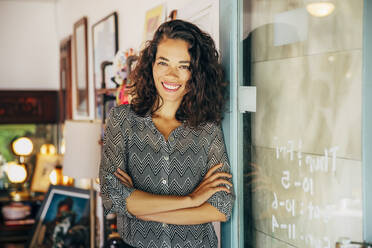 Mixed race entrepreneur standing in store - BLEF07563