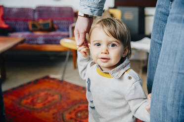 Caucasian mother helping baby son walk - BLEF07581