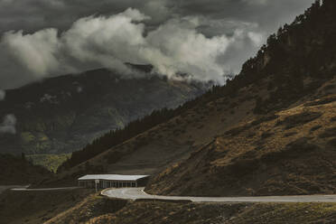 Dramatic landscape of storm clouds and road on Midi-Pyrenees, France - OCAF00423