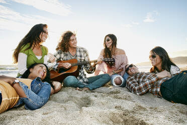 Friends relaxing together on beach - BLEF07625