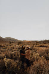 Couple in field landscape, Kennedy Meadows, California, US - ISF21793