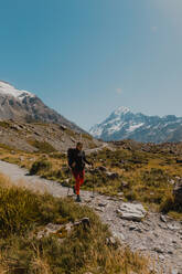 Hiker exploring trail, Wanaka, Taranaki, New Zealand - ISF21876