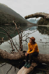 Woman enjoying scenic lake view, Queenstown, Canterbury, New Zealand - ISF21909