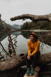 Woman enjoying scenic lake view, Queenstown, Canterbury, New Zealand - ISF21910