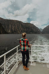 Woman on lake cruise, Queenstown, Canterbury, New Zealand - ISF21919