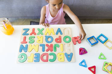 Mädchen spielt mit Alphabet Lernspiel zu Hause - JPTF00202