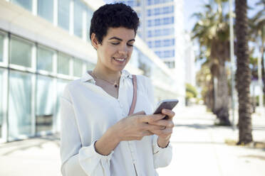 Woman using smartphone in the city - JSRF00324