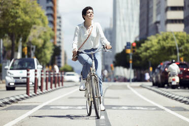 Woman with bike on bicycle lane - JSRF00347