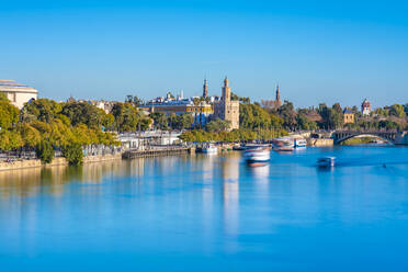 Long exposure of Guadalquivir River from Triana with the Torre del Oro, government buildings and Teatro de la Maestranza, Seville, Spain - TAMF01570