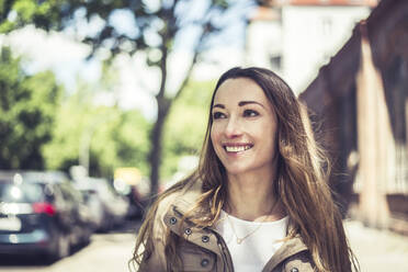 Portrait of smiling woman in the city - BFRF02044