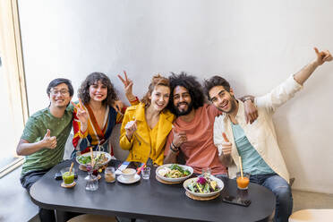 Portrait of happy group of friends in a restaurant - AFVF03480