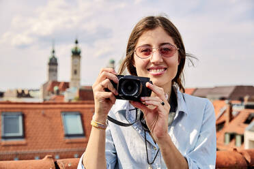 Young smiling woman taking picture - SUF00569