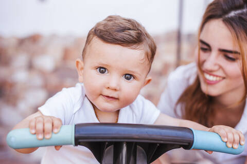 Mother with her son on tricycle stock photo