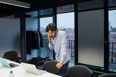 Businessman using smartphone in office - CUF51810