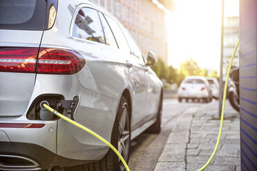 Electric car gettig charged at an charging station - MAMF00775