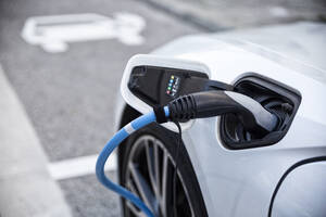 Electric car gettig charged at an charging station - MAMF00776