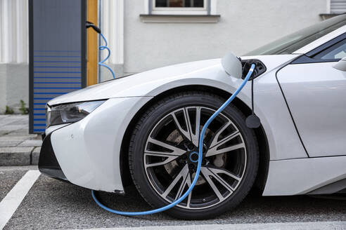 Electric car gettig charged at an charging station - MAMF00782