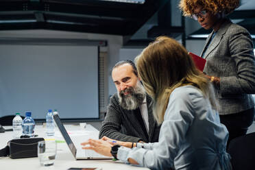 Business partners at brainstorming meeting in office - CUF52318