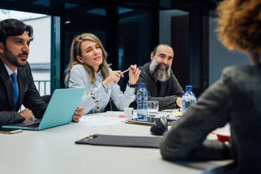 Business partners at brainstorming meeting in office - CUF52320