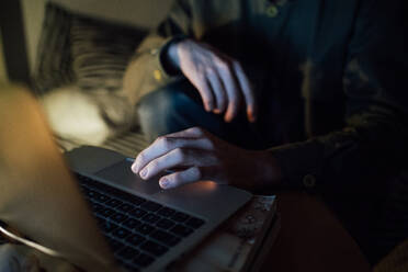 Man using laptop at home - CUF52340