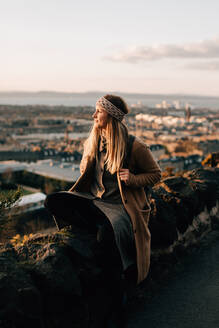 Woman enjoying view from Calton Hill, Edinburgh, Scotland - CUF52487