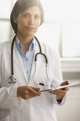 Hispanic doctor using digital tablet - BLEF07815