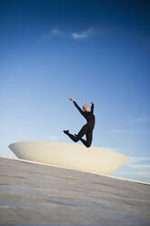 Brazilian dancer jumping in mid-air outdoors - BLEF07842