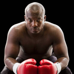 African American boxer wearing boxing gloves - BLEF07875