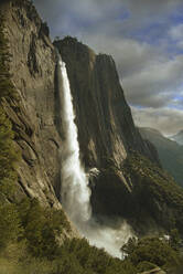 Waterfall over rock formations, Yosemite, California, United States - BLEF07940