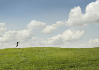 Girl running in rural landscape - BLEF07973