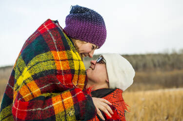 Caucasian couple wrapped in blankets outdoors - BLEF08111