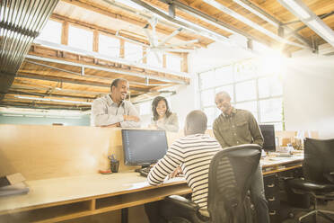 Business people working together at desk in office - BLEF08144