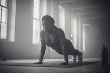 Premium Photo  Strong athletic black woman in a gym doing push-up